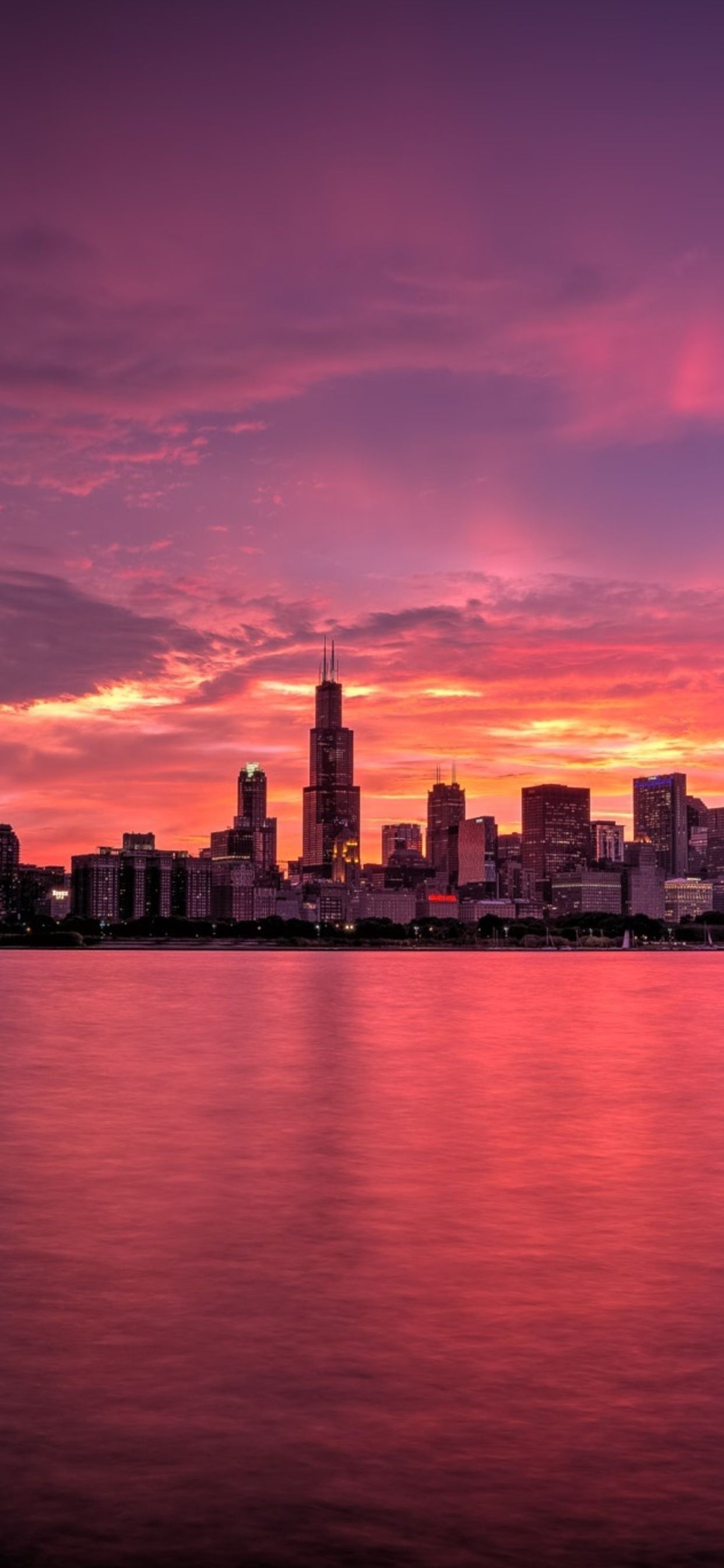 A city skyline is seen at sunset - Sunrise, Chicago