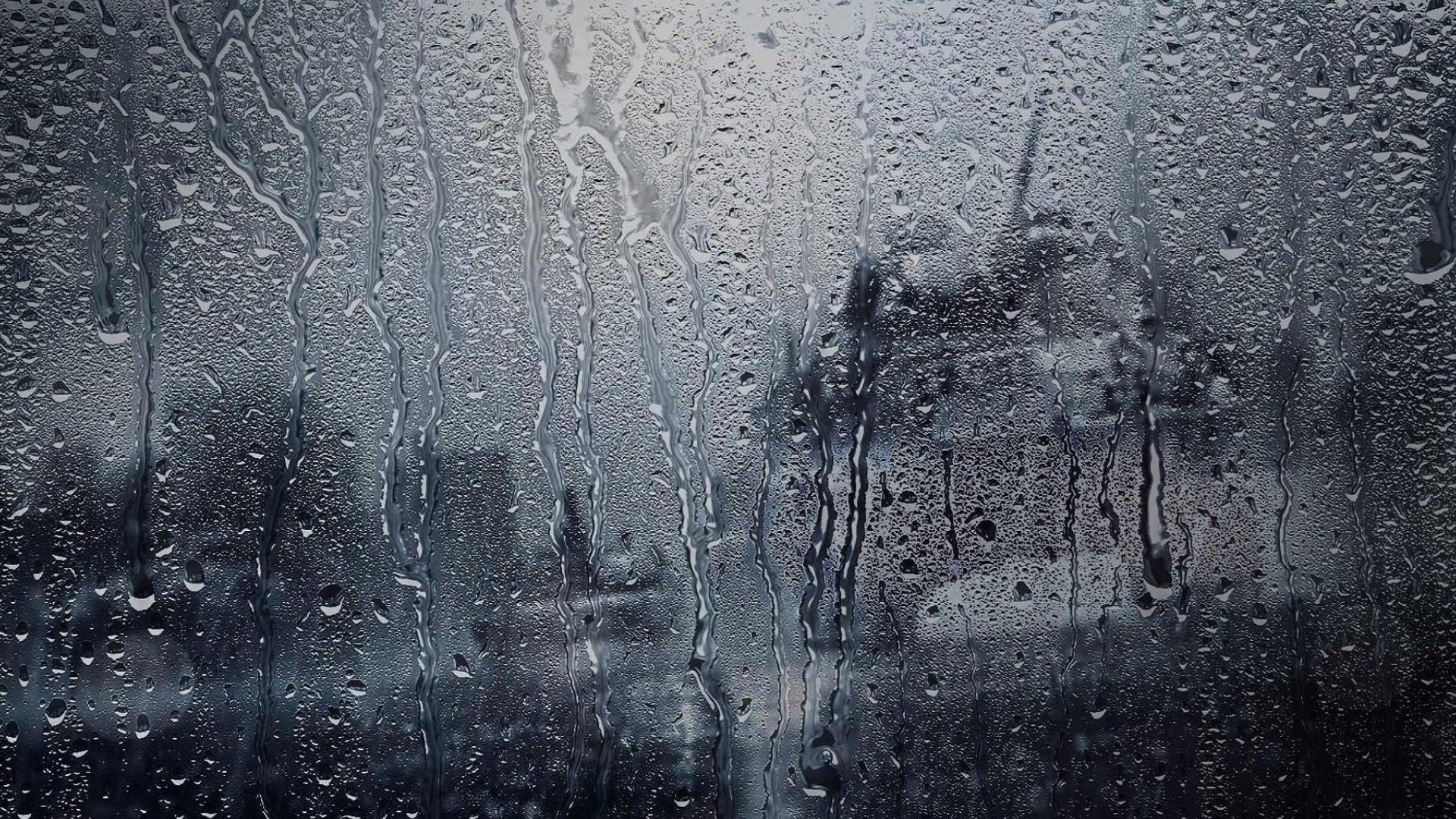 Raindrops on a window, looking out to a dark, wet day - Rain