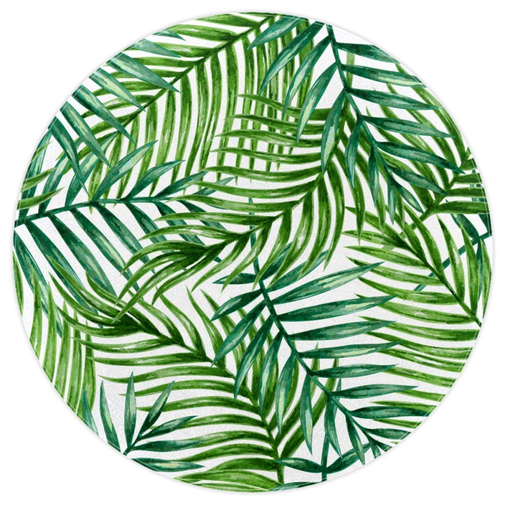 A round white rug with a green palm leaf pattern - Minimalist